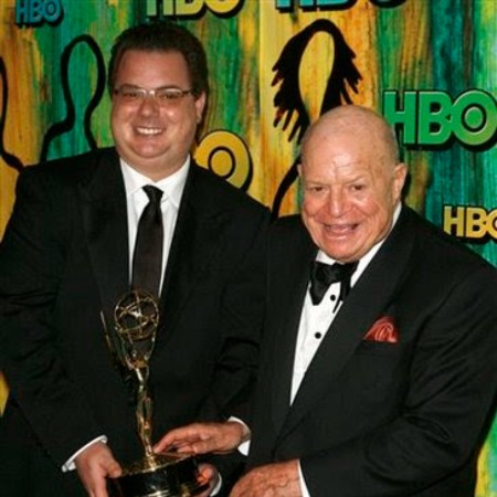 Larry Rickles and his father Don Rickles holding an award.